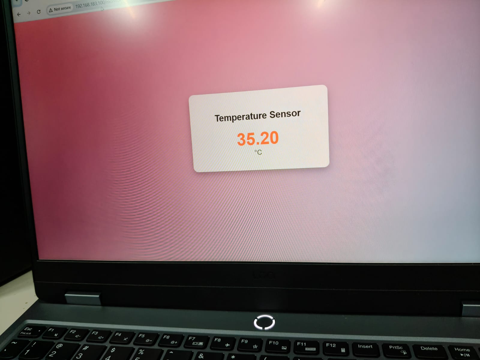 An LED blinking on a breadboard connected to a microcontroller.